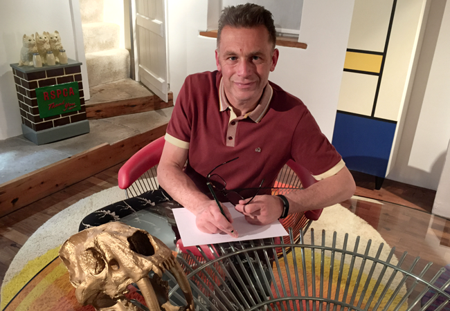 Chris Packham signing the limited edition Songbird Stamps Collector Card